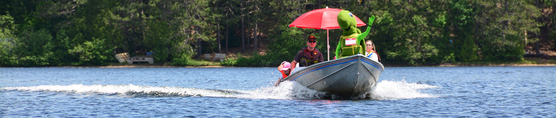 Tupper the Turtle riding a boat on a lake in Highlands East.