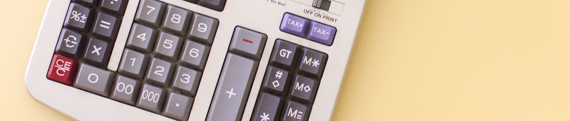 A top down view of a calculator on a table.