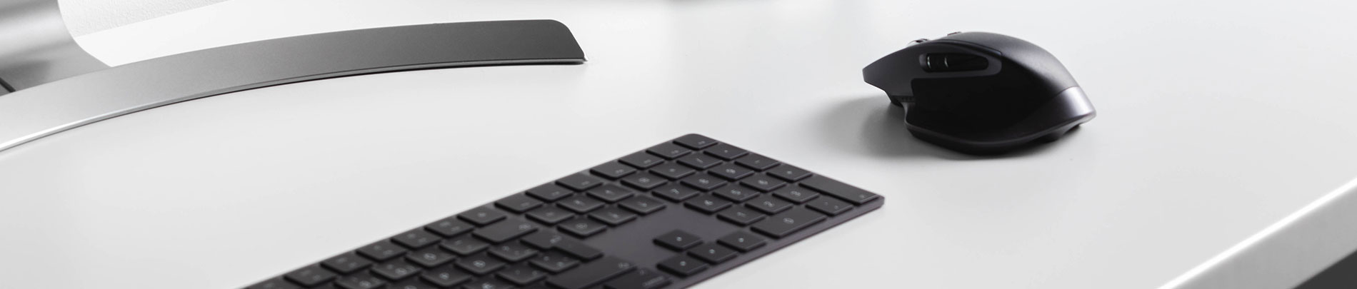 A person's desk with mouse, keyboard and monitor.