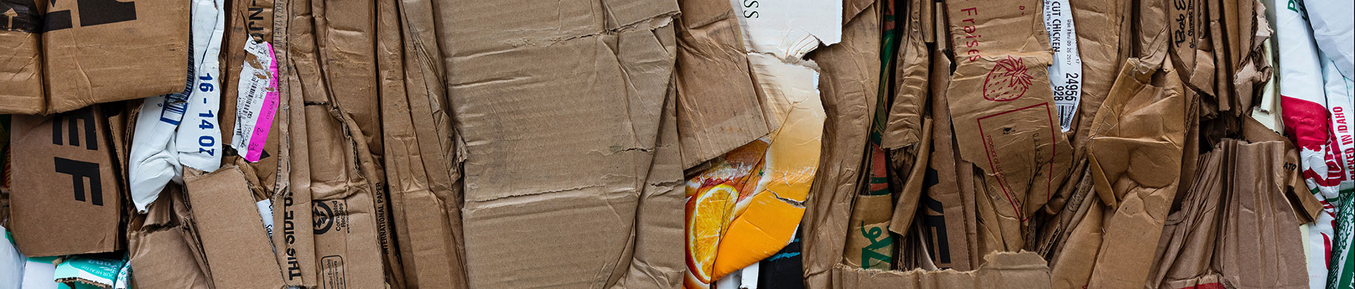 Stacked and compressed cardboard for recycling.