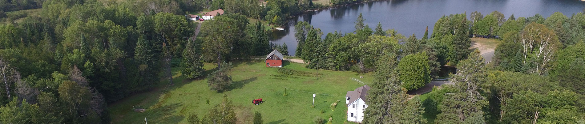 An aerial photo of South Wilberforce showing an old farm, forest and lakes.