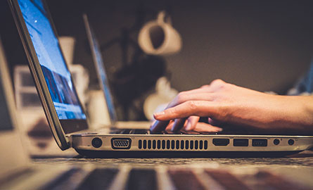 A person using a laptop computer.