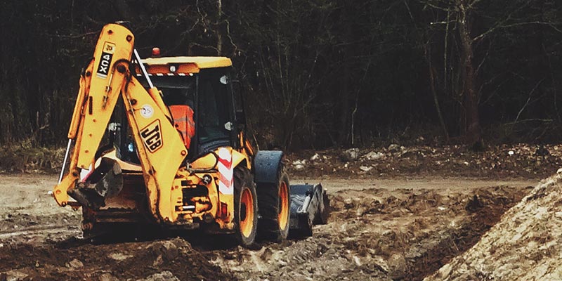 A municipal backhoe at a worksite.