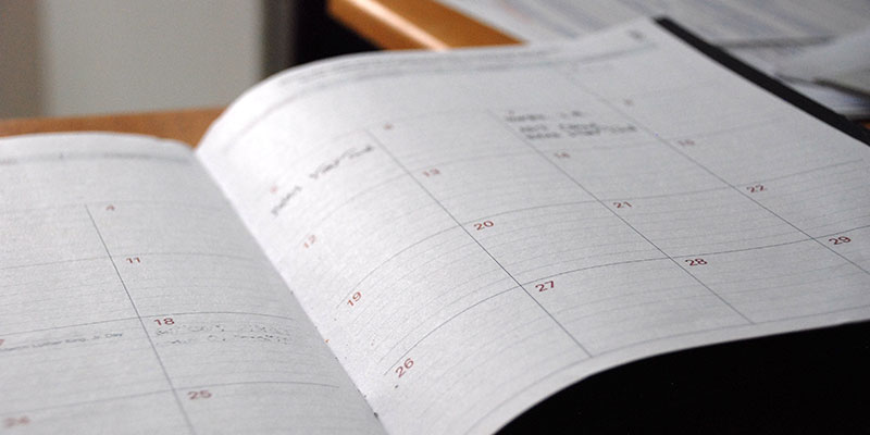 An open calendar book on a table.