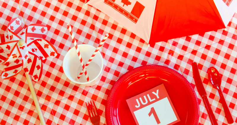 Red and white picnic items, a July 1 calendar page with a pinwheel and umbrella for Canada Day.