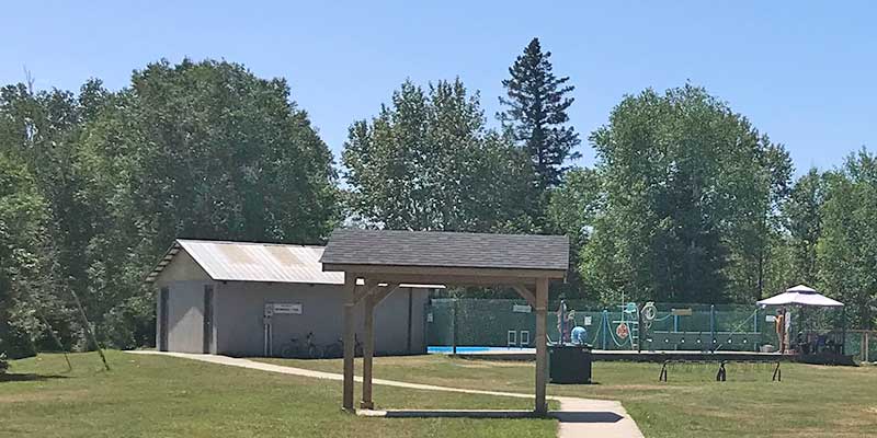 An exterior photo of the Cardiff Pool and surroundings on a sunny, summer day.
