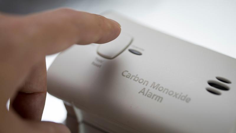 Person testing a carbon monoxide detector.