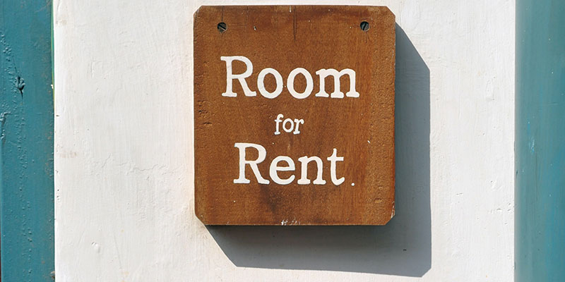 A wooden sign that reads room for rent