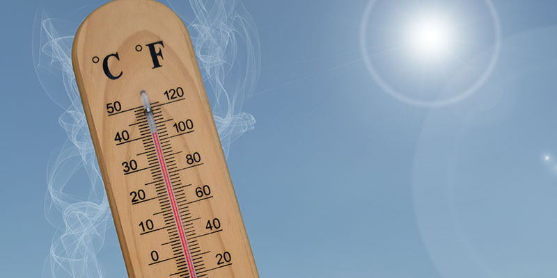A thermometer reaches over 40 degrees C with heat waves, smoke and a burning sun in the background.