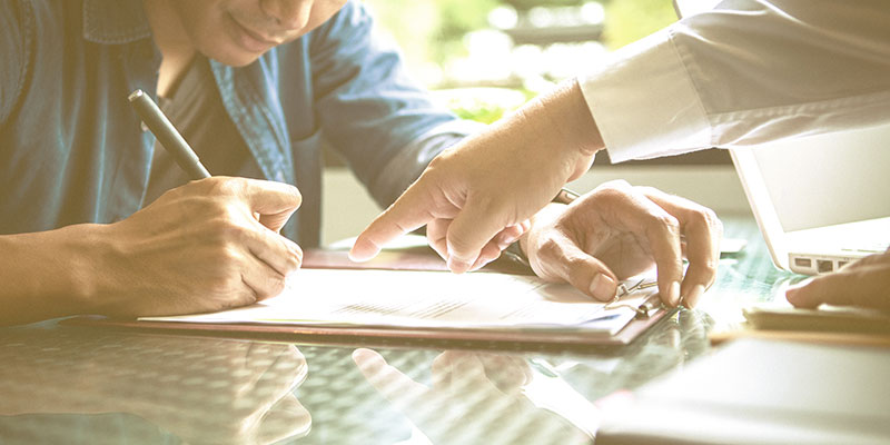 Person filling out a form.