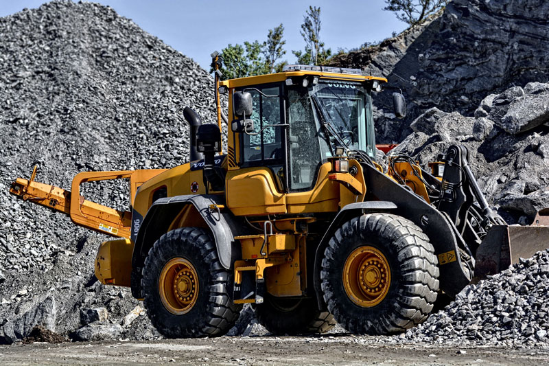 A loader amongst piles of aggregate.