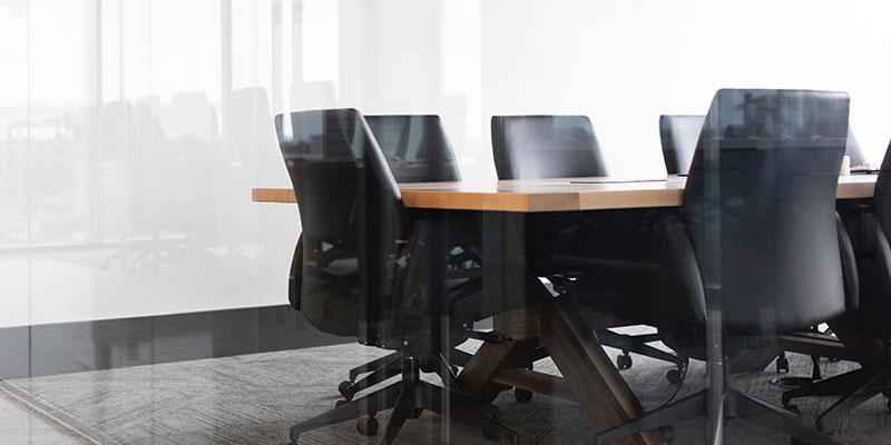 A meeting room with table and chairs.