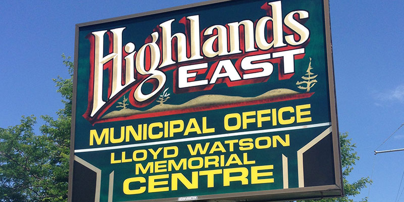 The green and yellow Municipality of Highlands East sign outside the office in Wilberforce.
