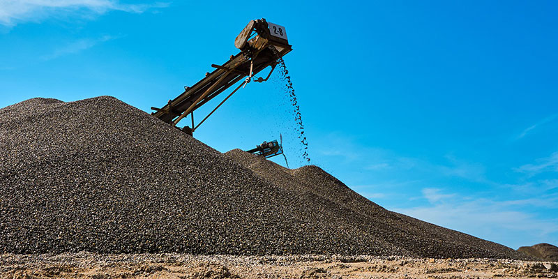 A gravel pile being made by a crusher's conveyor belt.