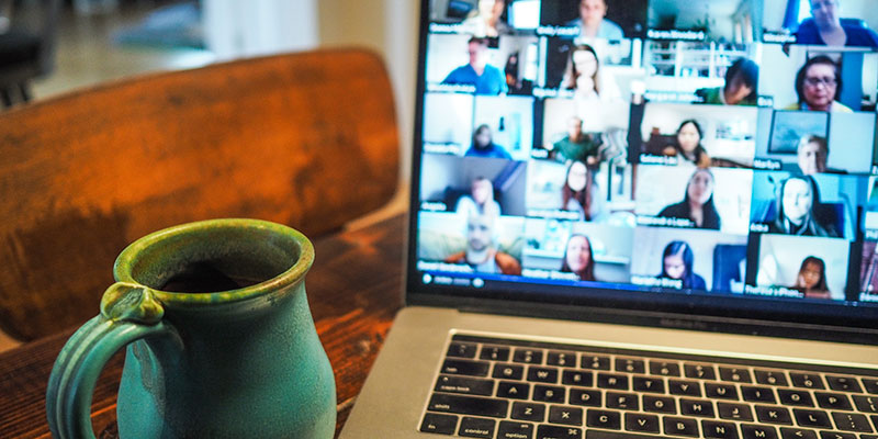 A home computer with a video conference pulled up on the screen.