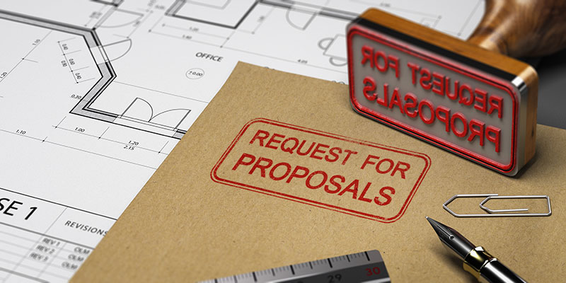 A folder stamped with Request for Proposal sits on a desk